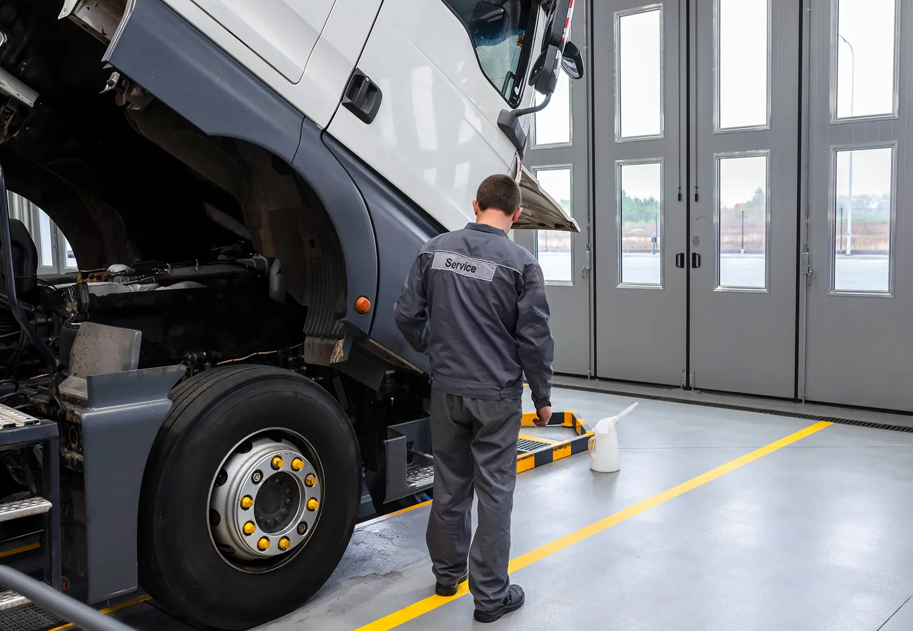 HGV Mechanic Inspecting Vehicle